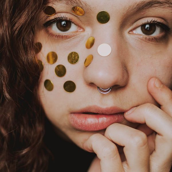 Close-up of a person's hands in a meditative pose.